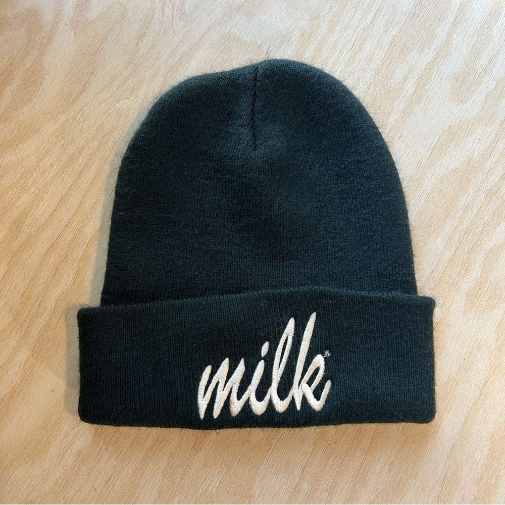 Black beanie with white font “Milk”